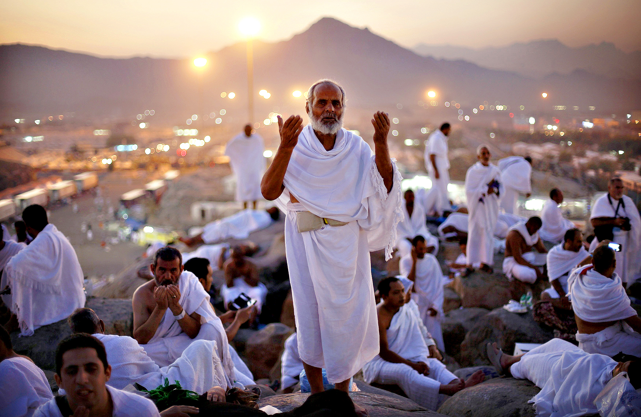 A Muslim pilgrim prays atop Mount Mercy on the plains of Arafat during the peak of the annual haj pilgrimage, near the holy city of Mecca...A Muslim pilgrim prays atop Mount Mercy on the plains of Arafat during the peak of the annual haj pilgrimage, near the holy city of Mecca early morning October 14, 2013. An estimated two million Muslims were in Mecca, Saudi Arabia, on Monday morning for the start of the annual Haj pilgrimage. REUTERS/Ibraheem Abu Mustafa (SAUDI ARABIA - Tags: SOCIETY RELIGION)