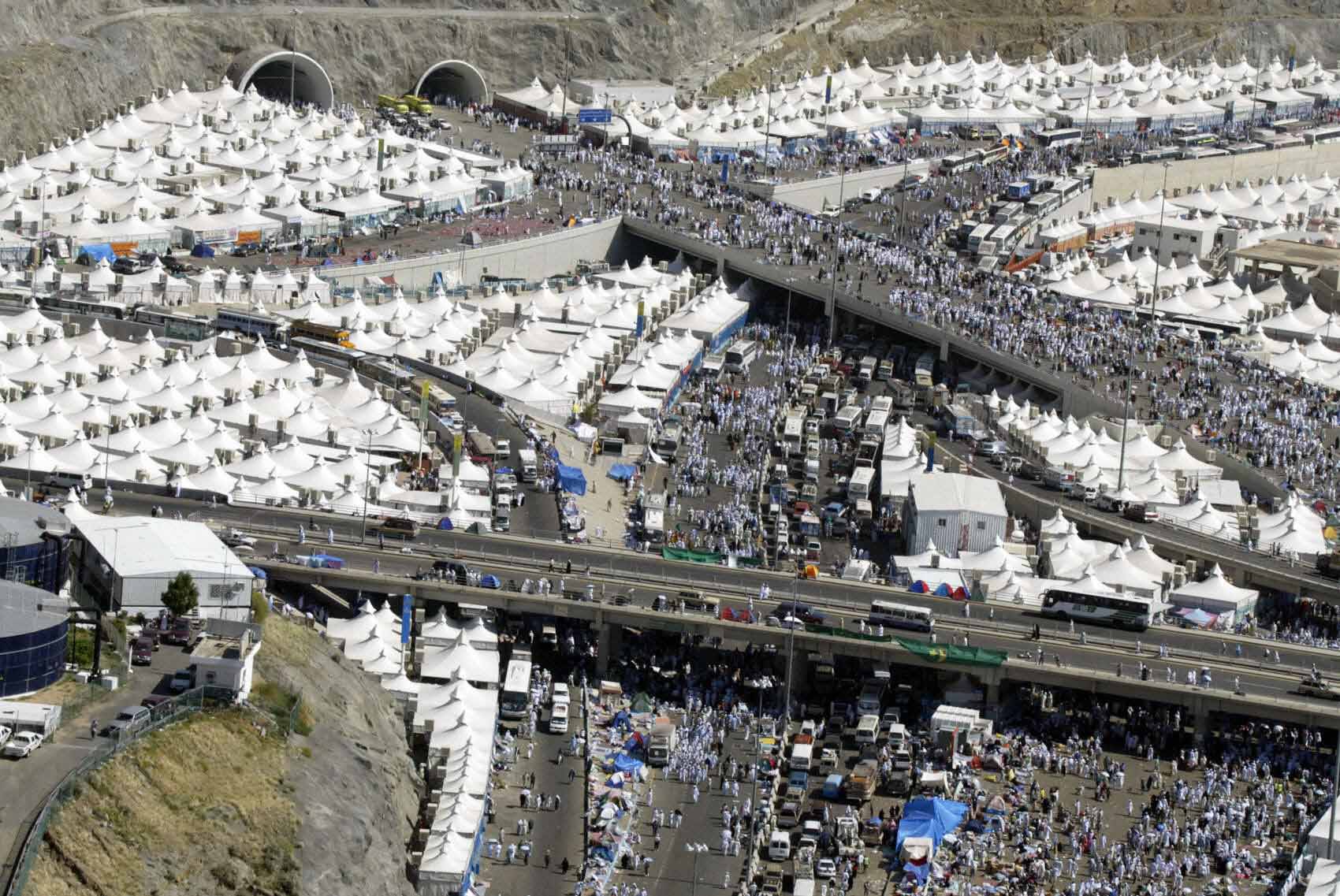 An aerial view of Mina, near Mecca, shows scores of Muslim pilgrmis walking towards the spot where they stone the devil, one of the rituals of the last stage of the annual hajj pilgrimage, on second day of Eid Al-Adha, 02 February 2004. Saudi Arabia's King Fahd has ordered "overall plans" to be drawn up to modernise the holy cities of Mecca and Medina after 251 pilgrims died in a stampede, according to the official Saudi media. AFP PHOTO/Awad AWAD