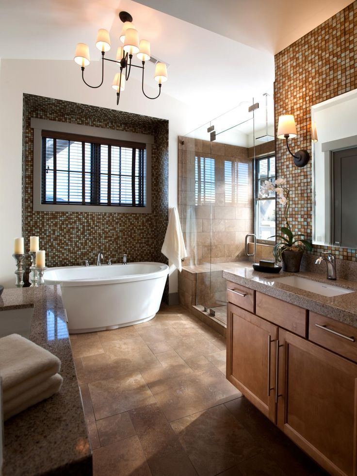 A study in neutrals, the master bathroom showcases Turkish travertine tile, maple cabinetry in a chestnut finish and iridescent glass mosaic tile.
